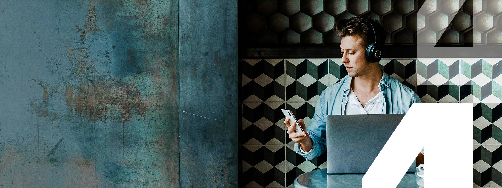 man with headphones sat at table