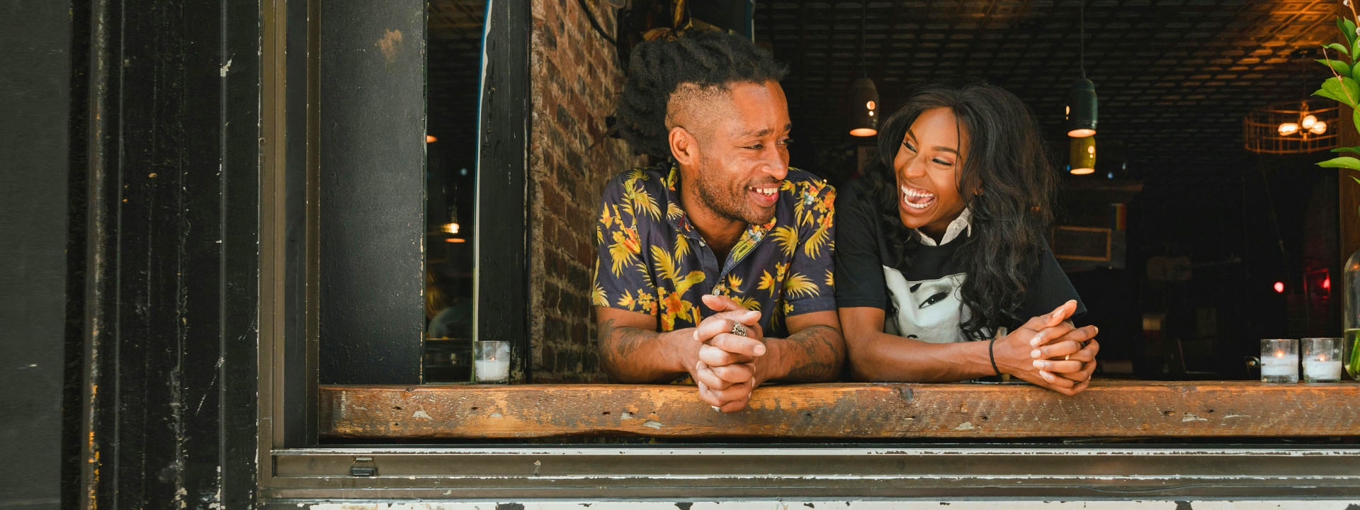 couple leaning out of window