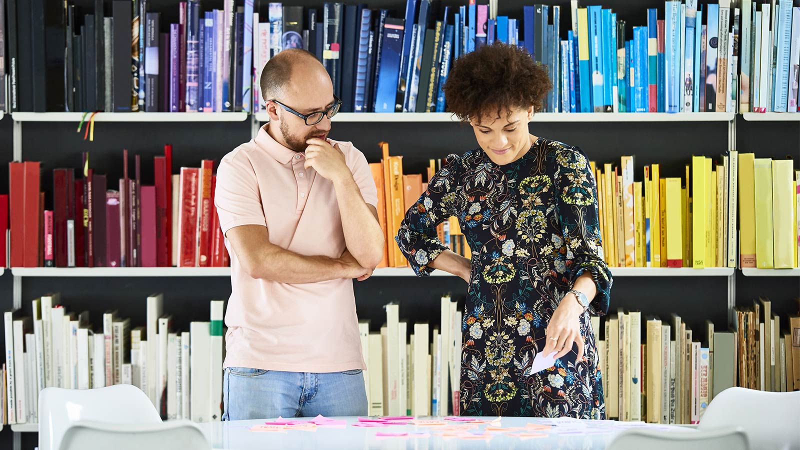 couple talking in front of books