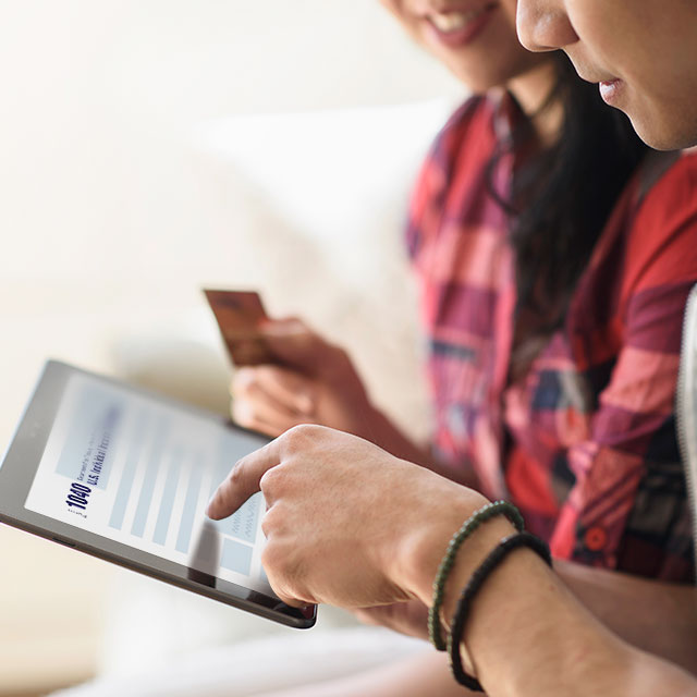 Two people working on 1040 tax form on tablet