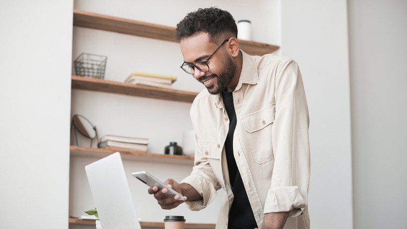 Man using laptop and phone