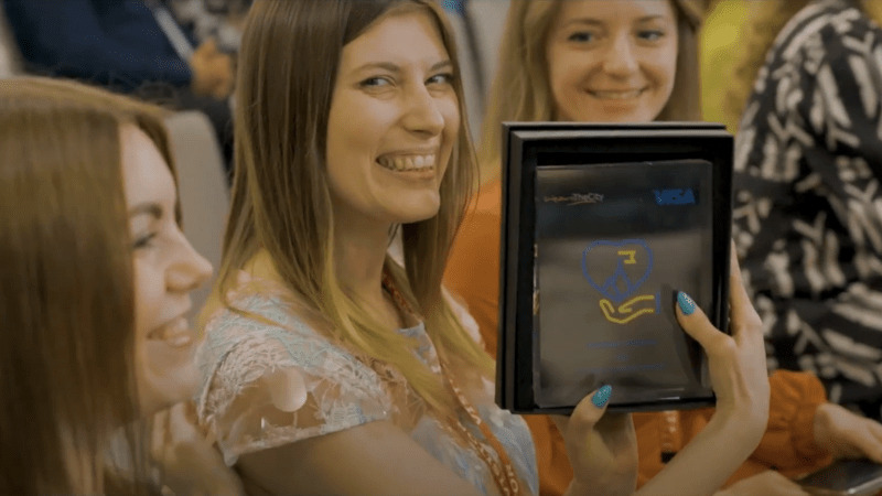 woman smiling holding ipad with icon