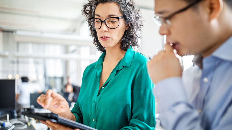 colleagues using tablet